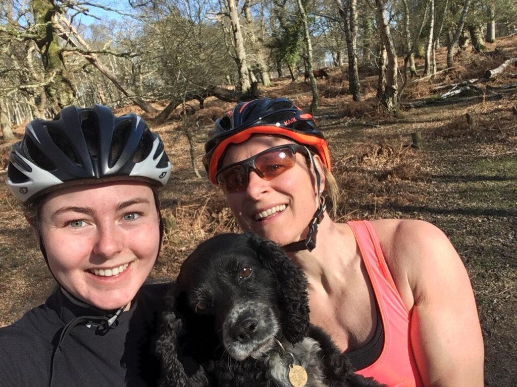 family with dog out for a bike ride 