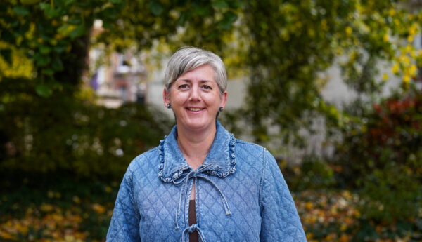 A woman with short hair in a blue jacket.