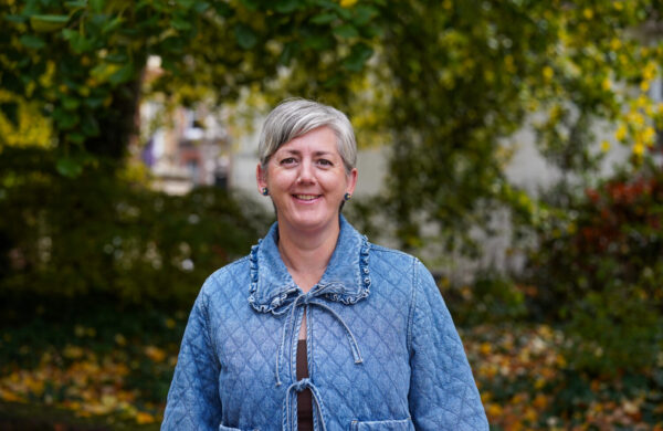 A woman with short hair in a blue jacket.