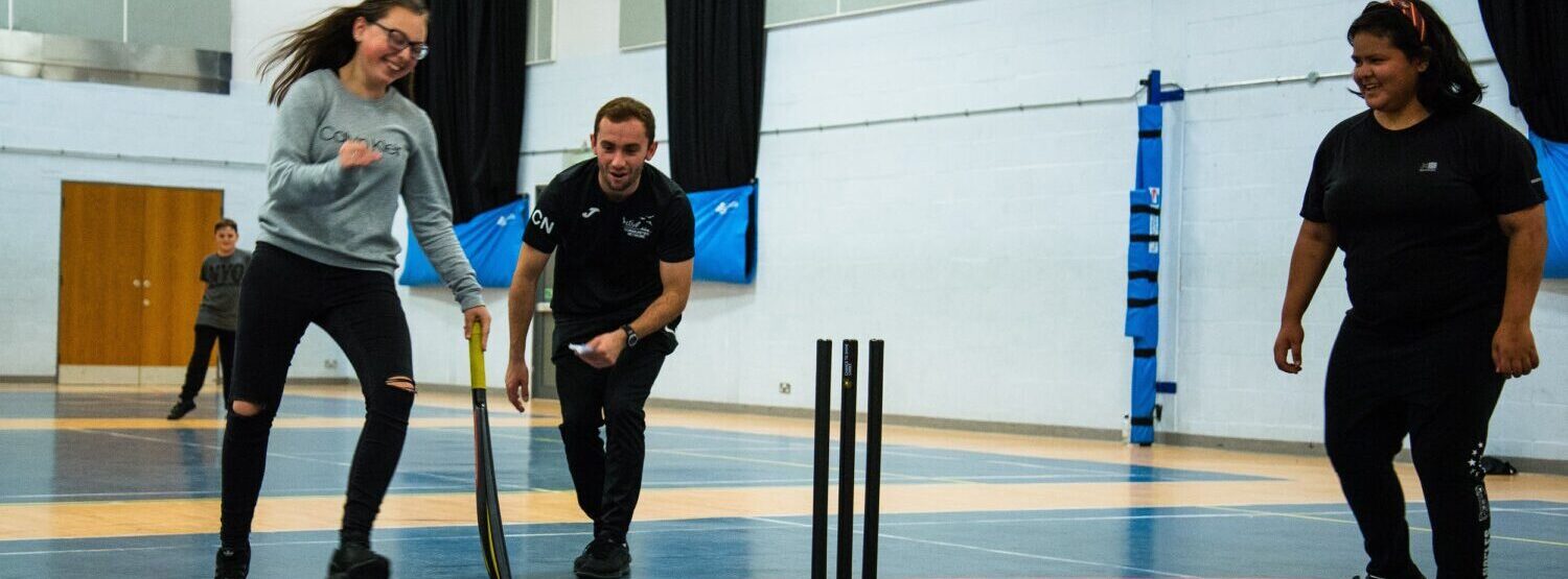 Coach supporting inclusive cricket