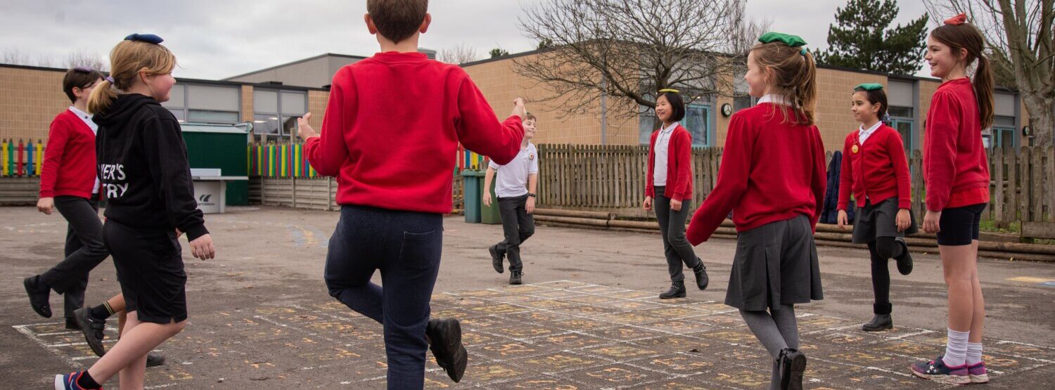 school activity break with pupils balancing in the playground