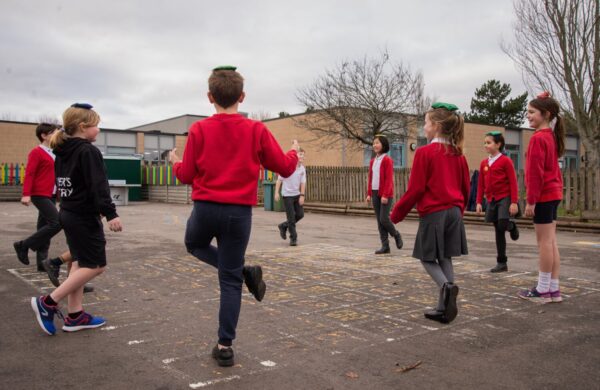school activity break with pupils balancing in the playground