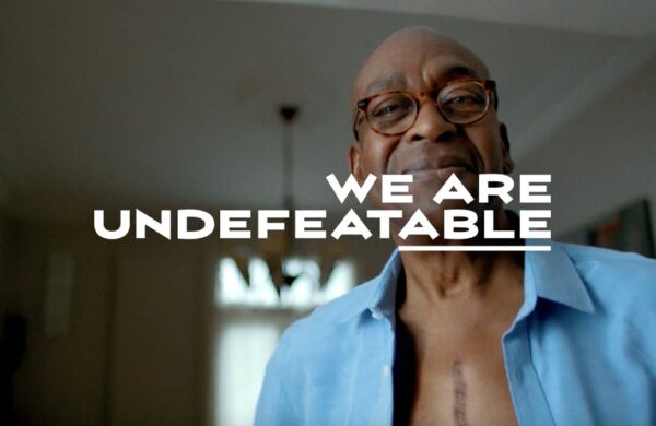 We Are Undefeatable campaign logo and man with surgery scar