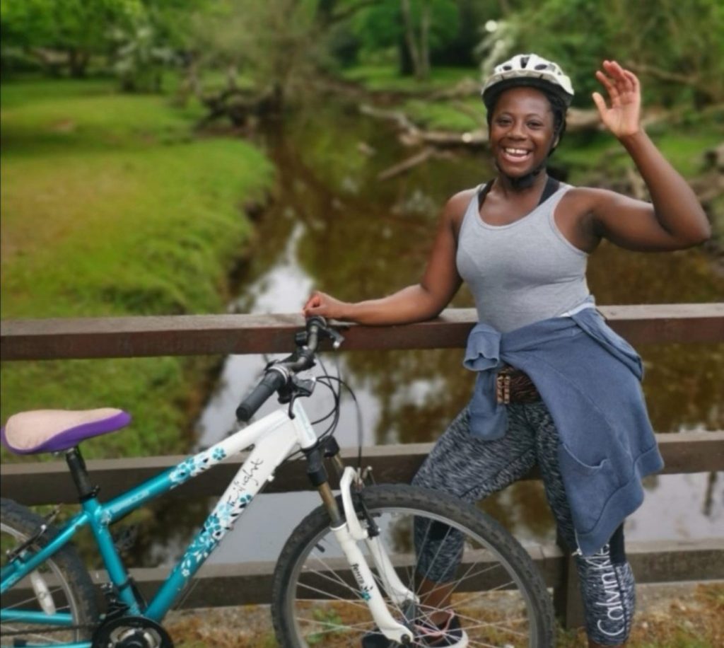 Kosiwa, standing with her bike