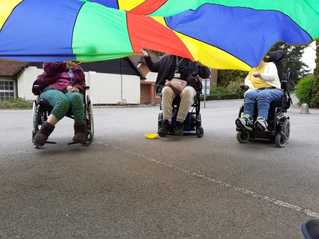 Enham Trust members playing parachute games