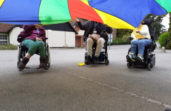 Enham Trust members playing parachute games