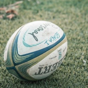 Coaching: A rugby ball laying on grass