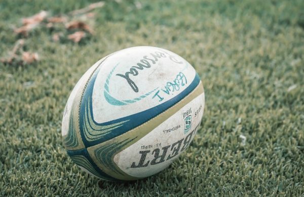 Coaching: A rugby ball laying on grass