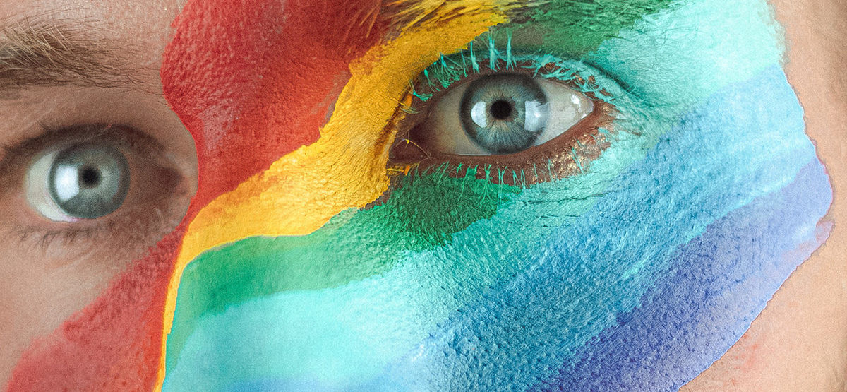 Pride Man with LGBT rainbow flag painted on face