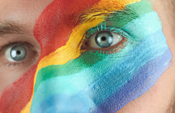 Pride Man with LGBT rainbow flag painted on face