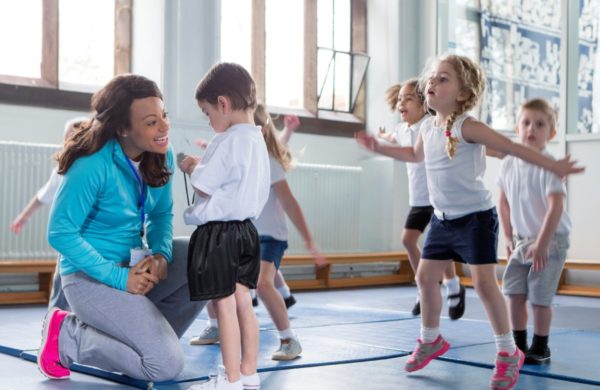 PE teacher with children in lesson