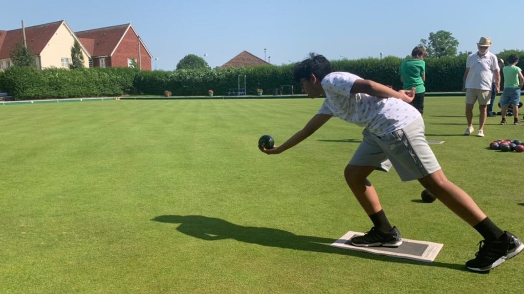 Young boy playing bowls