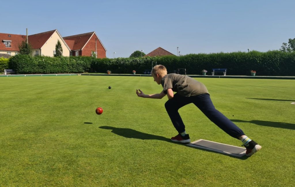 Young boy playing bowls