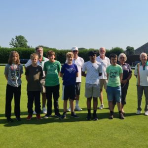 Bowls club and school children posing together
