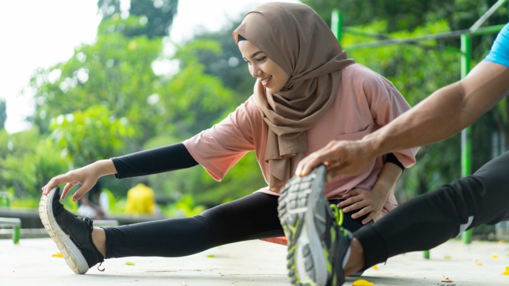 Lady in Hijab stretching (Diversity and Inclusion plan)