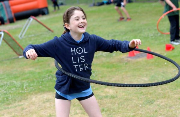 Girl playing thanks to Opening school facilities project