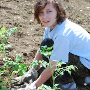 Child gardening and taking part in bushcraft activities