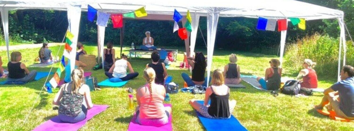 Alla teaching an outdoor yoga class in the summer.