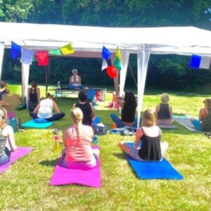 Alla teaching an outdoor yoga class in the summer.
