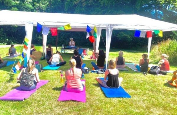 Alla teaching an outdoor yoga class in the summer.