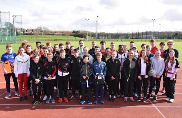 A group of people stood on an athletics track