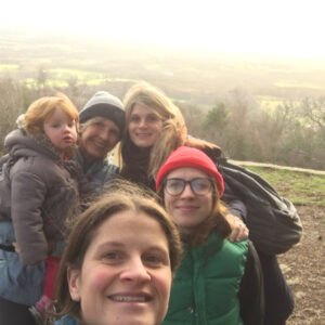 A family posing at the top of a hill.