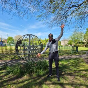 A man posing in the park.