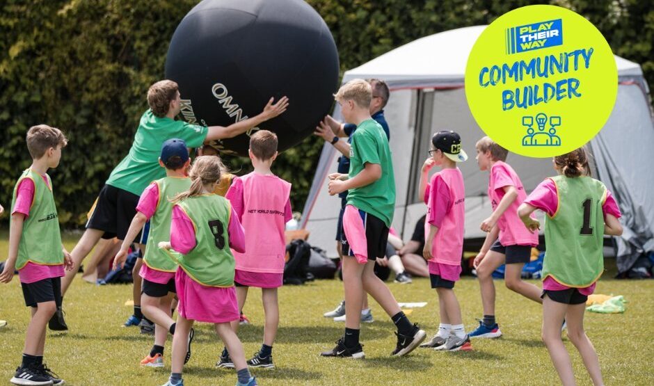 A group of children playing Kinball.