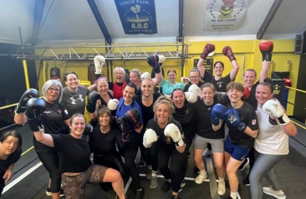 A group of women wearing their boxing gloves.