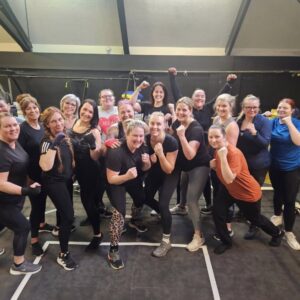 A group of women holding their hands in an uppercut position.