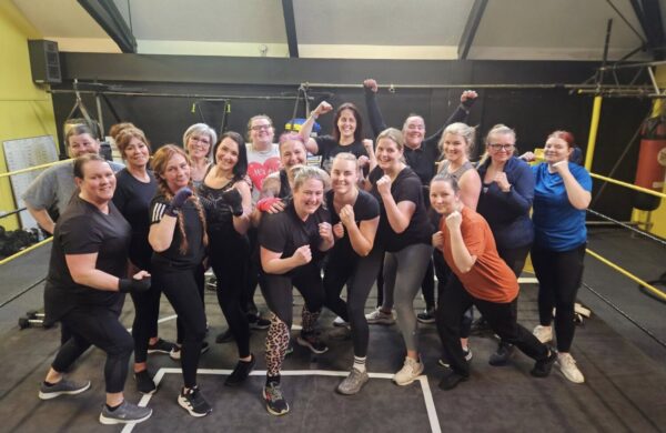A group of women holding their hands in an uppercut position.