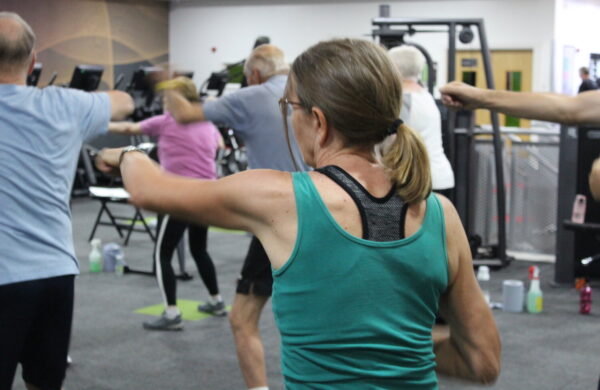 A woman punching forwards as part of her exercise class.