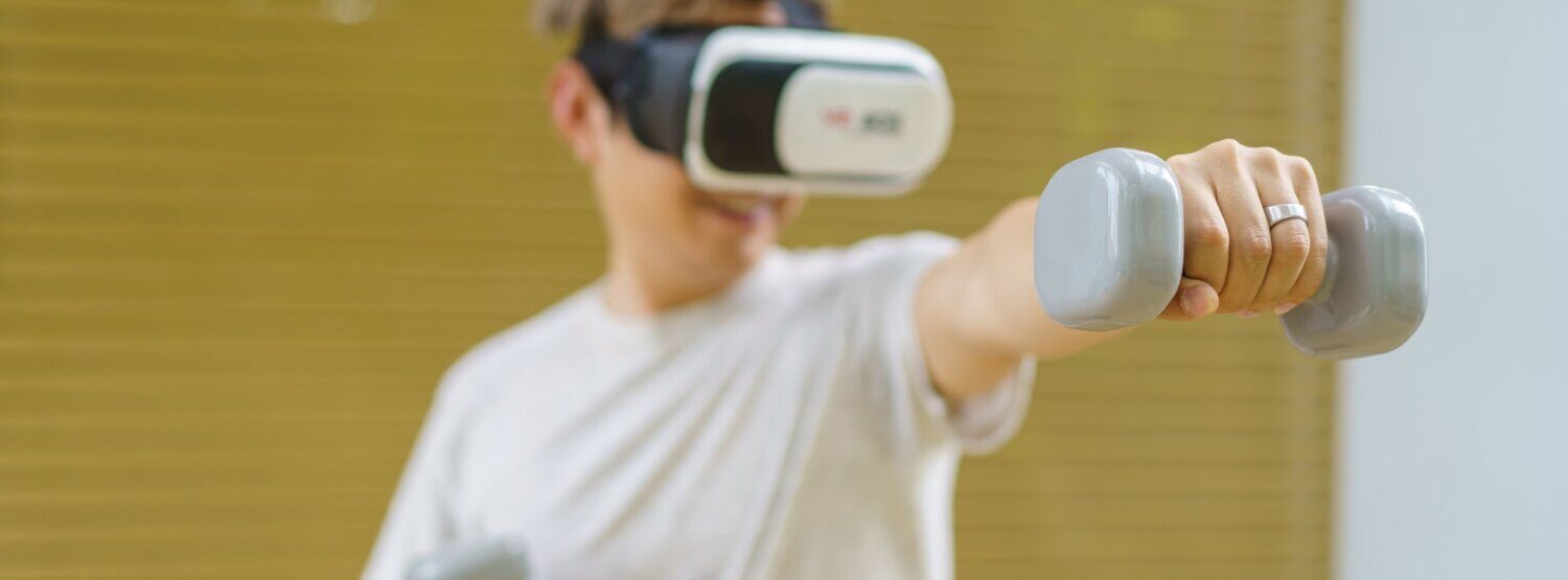 A person wearing a VR headset and holding weights.
