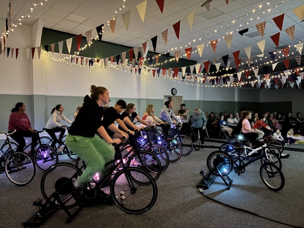 People cycling indoors.