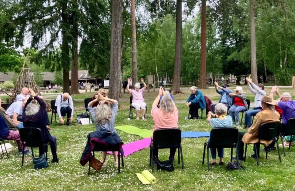 An outdoor chair-based yoga class.
