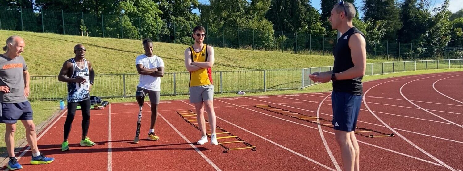 A coach talking to his participants on the track.