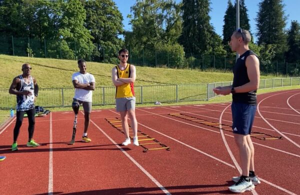 A coach talking to his participants on the track.