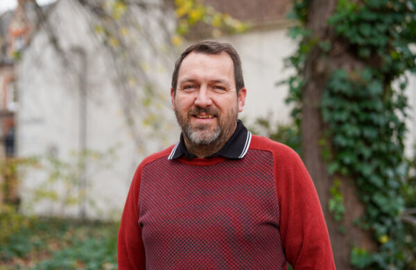 Man with a beard in a red jumper.
